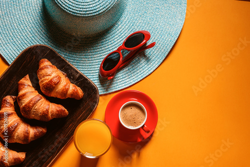 Canvas Print hat, sunglasses croissant with a cup of coffee and a glass of orange juice on a