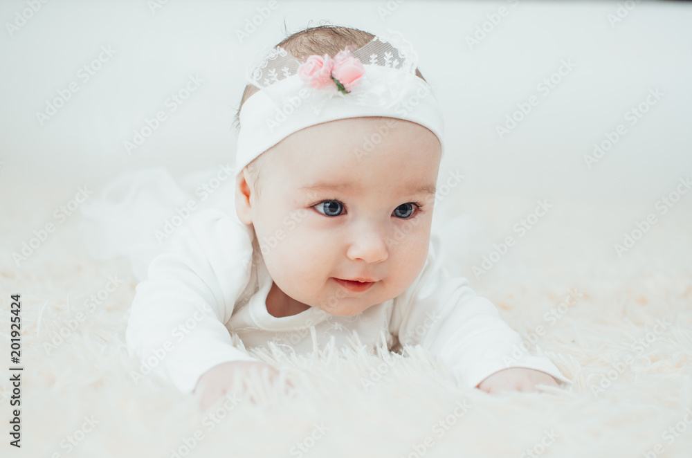 Portrait of an adorable girl lying on her belly close-up portrait Portrait of an adorable girl lying on her belly close-up portrait