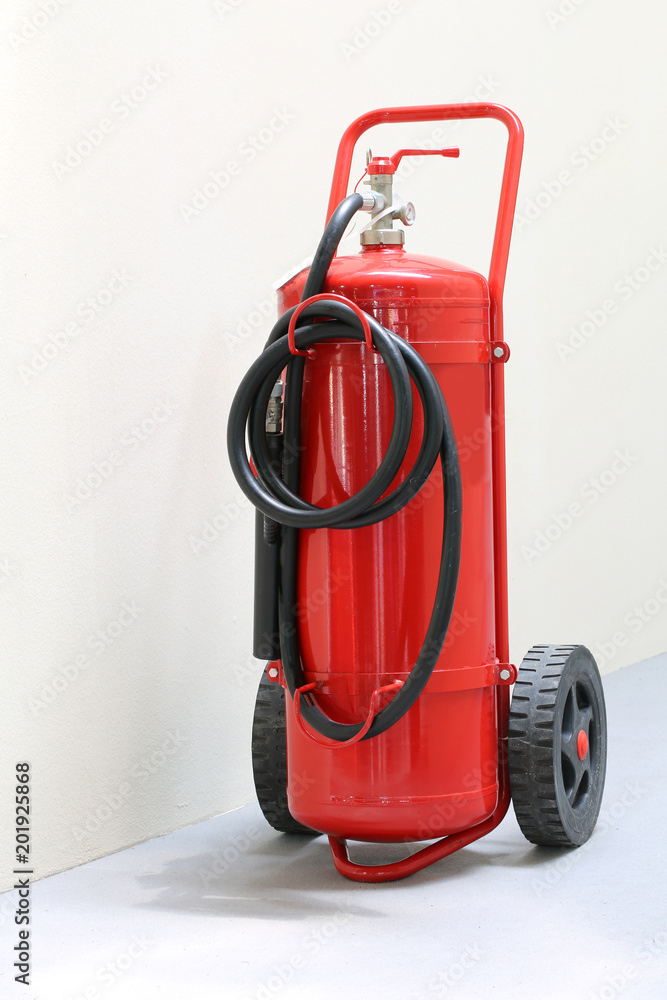 Naklejka premium red fire extinguisher ready in case of emergency fire