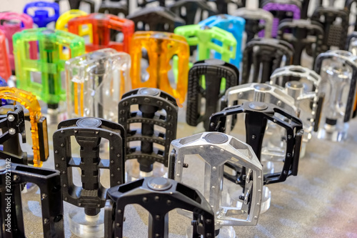 Many colorful bicycle pedals on store shelve.