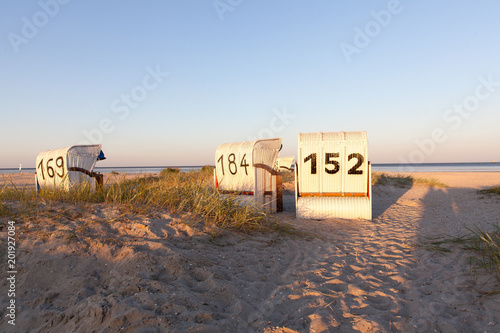 Strandkörbe an der Nordsee im Abendlicht photo