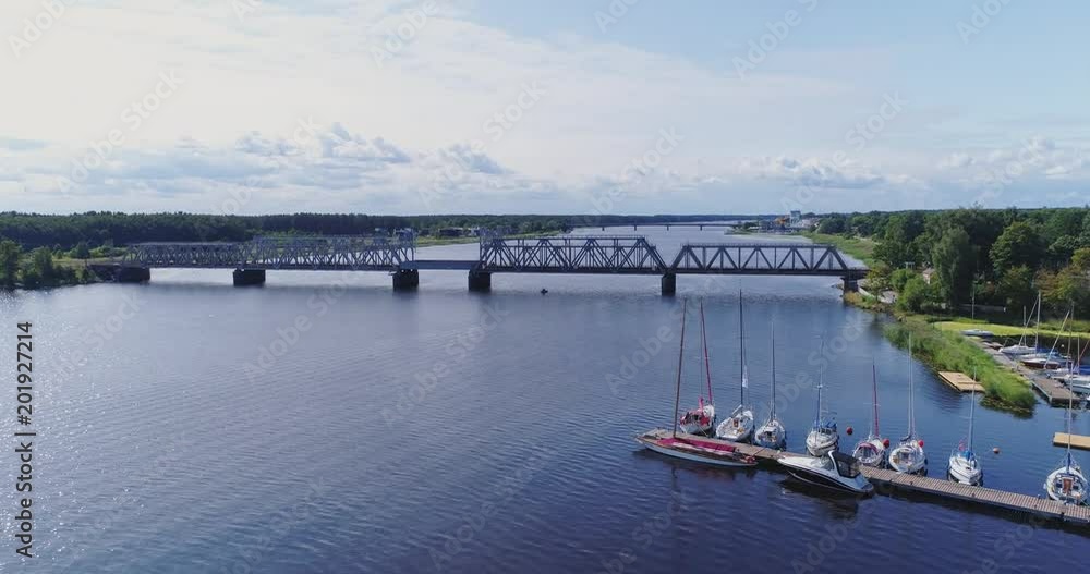 Yahts ships and boats on the Lielupe river near the train bridge Jurmala drone flight Yahts ships and boats on the Lielupe river near the train bridge Jurmala drone flight