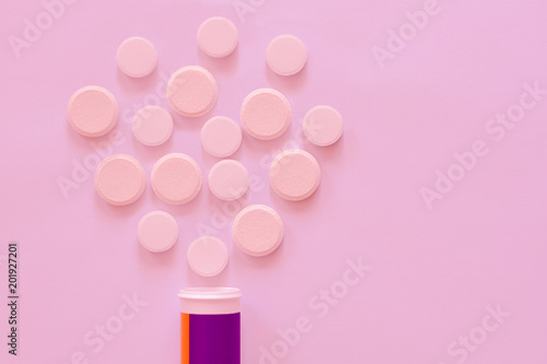 Medical tablets for health fitness slimming weight loss. Vitamins pill pills for health from a packaging jar on a pink background. Write copy paste photo