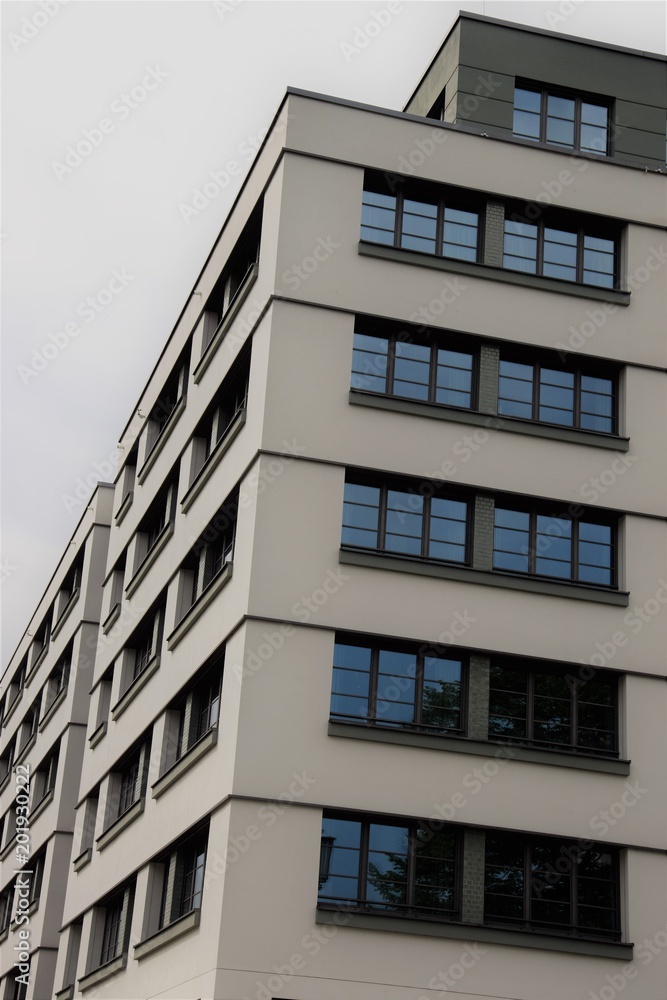 a modern office building with lots of windows a modern office building with lots of windows
