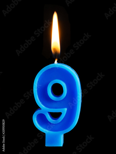 Burning birthday candle in the form of 9 nine figures for cake isolated on black background. The concept of celebrating a birthday, anniversary, important date, holiday, table setting