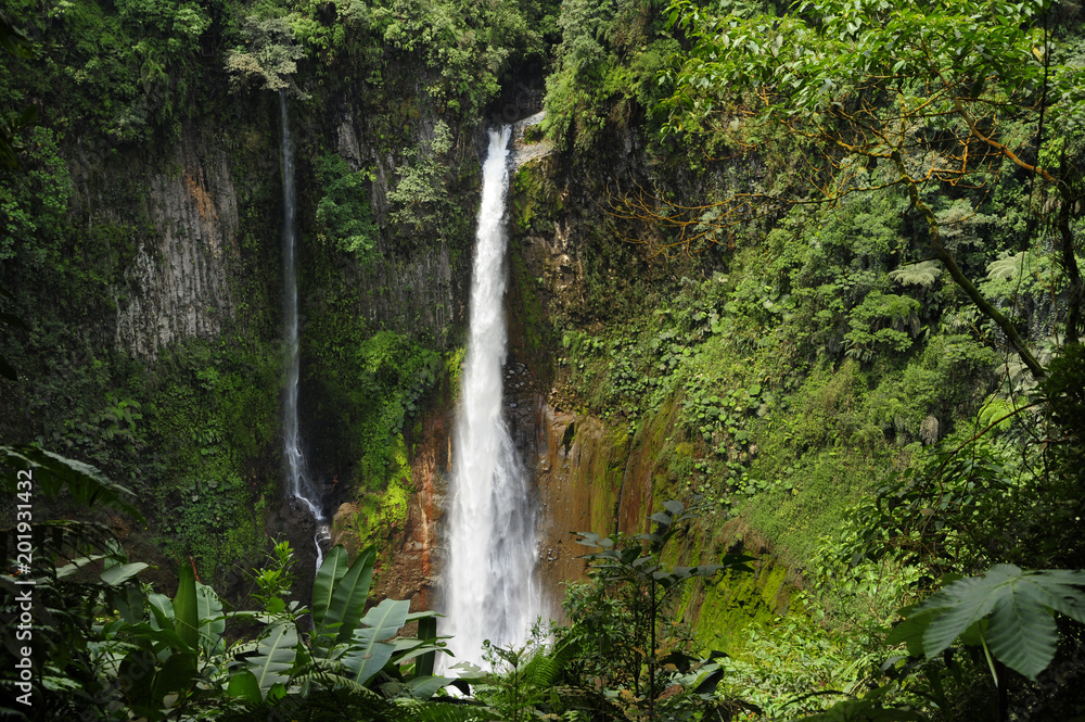 Catarata Del Toro waterfall cascades down into an old volcano crater. Catarata Del Toro waterfall cascades down into an old volcano crater.