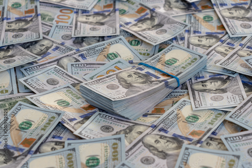 A pile of US banknotes with president portraits. Cash of dollar bills, dollar background image. A pile of US banknotes with president portraits. Cash of dollar bills, dollar background image.