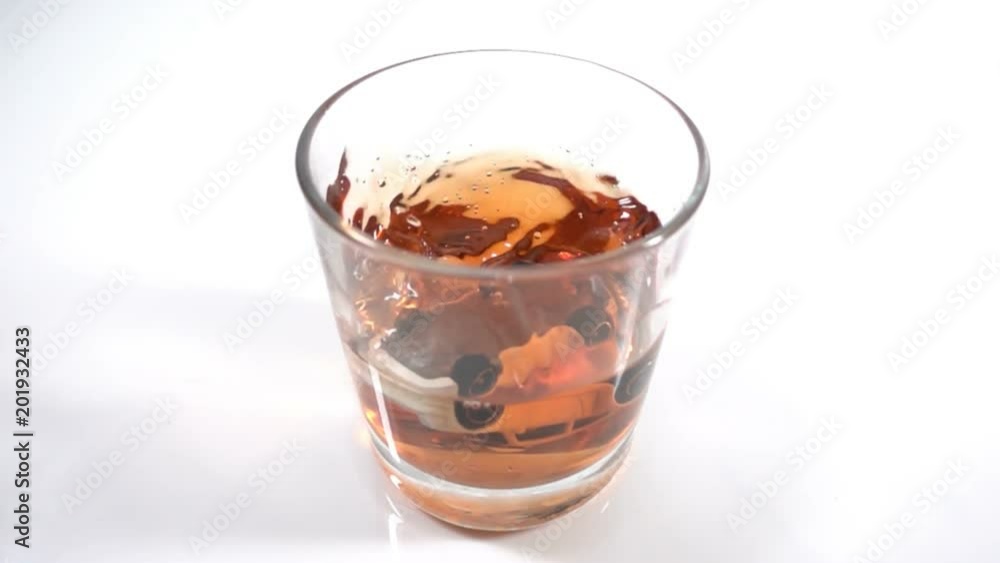 alcohol abuse, drunk driving - the car falls into a glass with alcohol, the concept of an accident while driving in a drunken state, Slow motion alcohol abuse, drunk driving - the car falls into a glass with alcohol, the concept of an accident while driving in a drunken state, Slow motion
