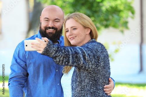 Overweight couple taking se...