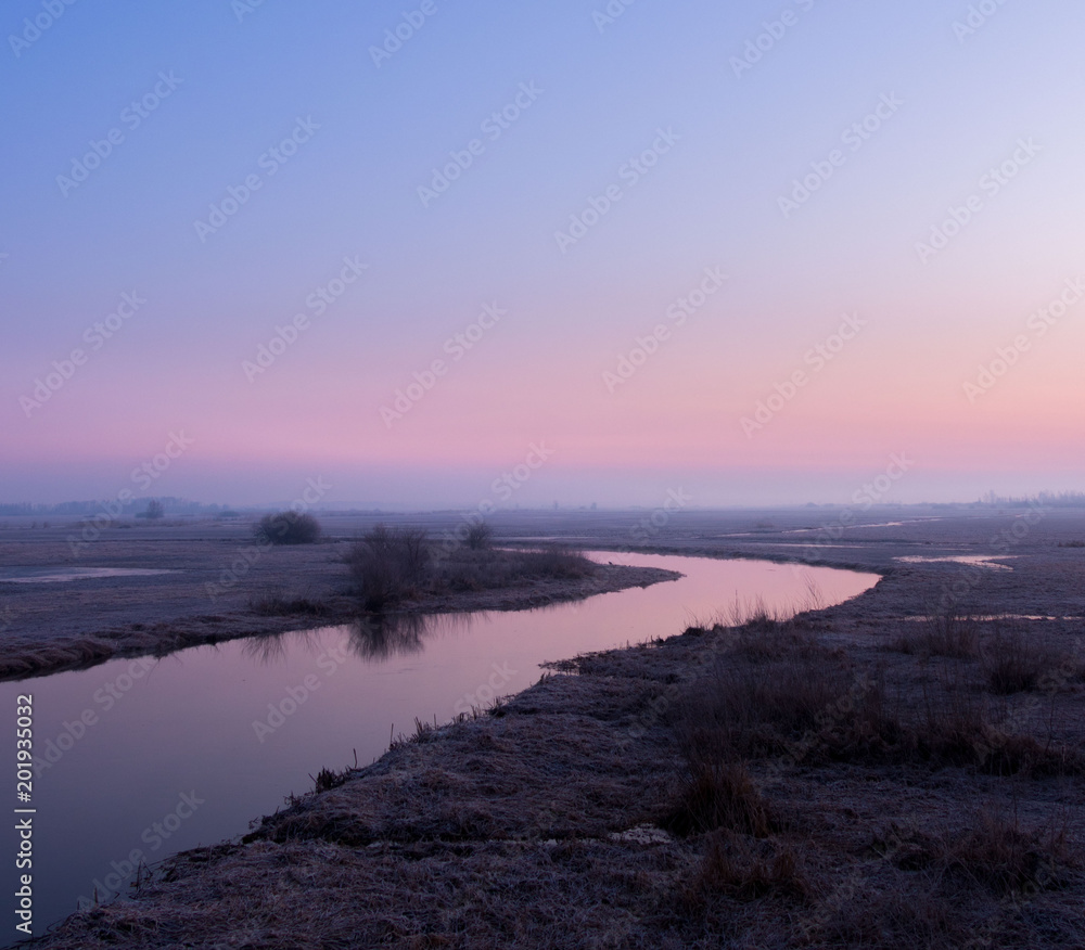 sunrise above the spring, frozen river 