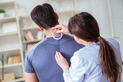 Doctor checking patients joint flexibility with gonimeter photo