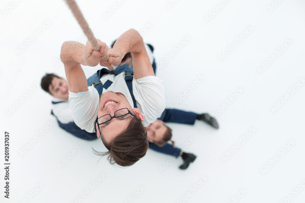 view from the top.young worker climbing up the rope view from the top.young worker climbing up the rope