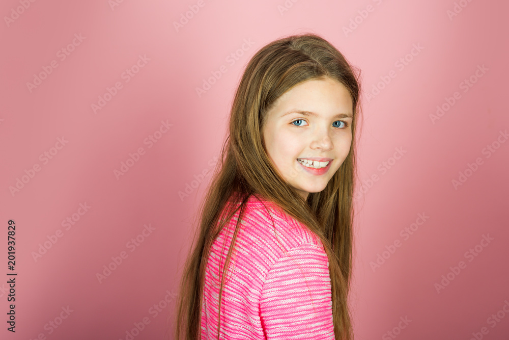 Little girl with long hair. Beauty and kid fashion with cosmetics and healthy hair. Hairdresser, skincare, casual style, denim. Stylish girl with pretty face on grey background. Little girl with long hair. Beauty and kid fashion with cosmetics and healthy hair. Hairdresser, skincare, casual style, denim. Stylish girl with pretty face on grey background.