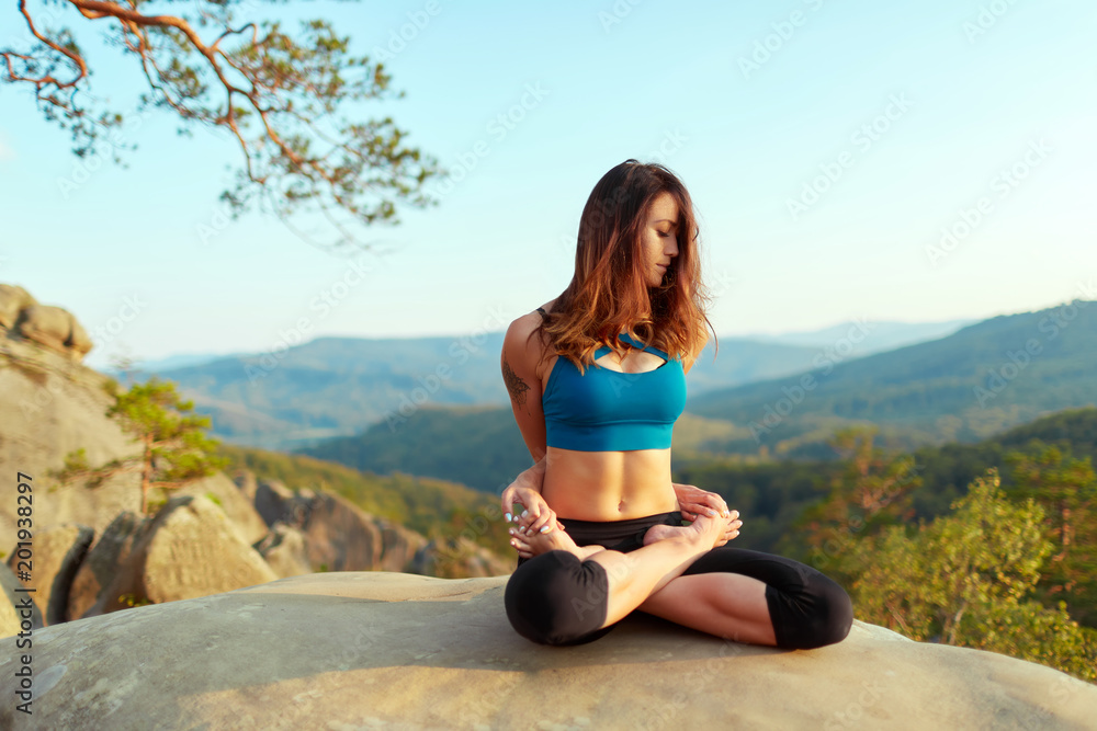 Young woman practicing yoga outdoors