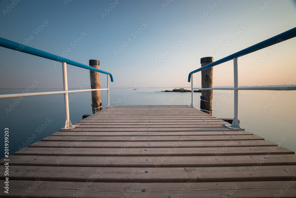 Wooden pier with blue railing