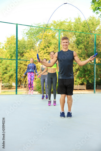 Young sporty people jumping...