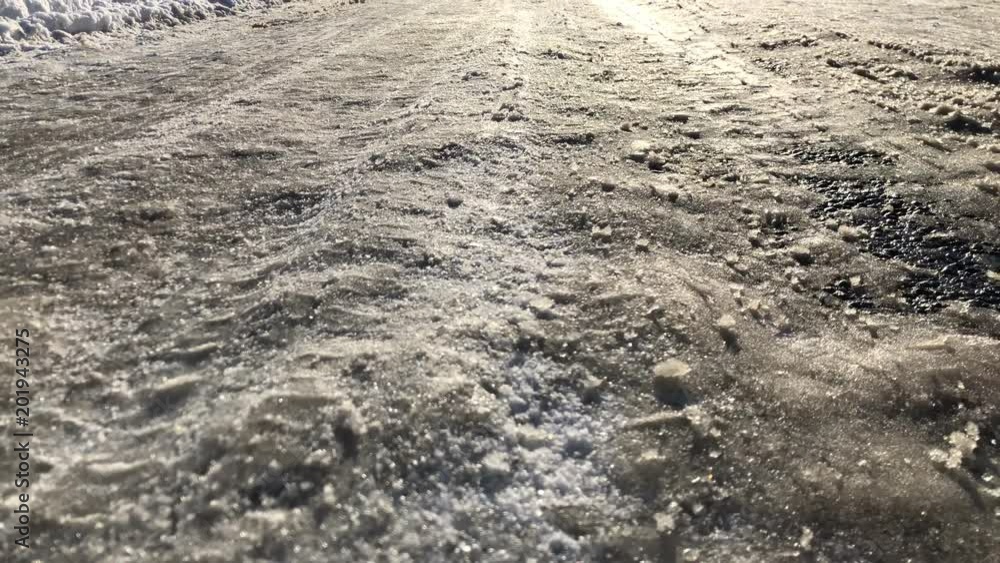 Winter driving conditions with thick ice on road Winter driving conditions with thick ice on road