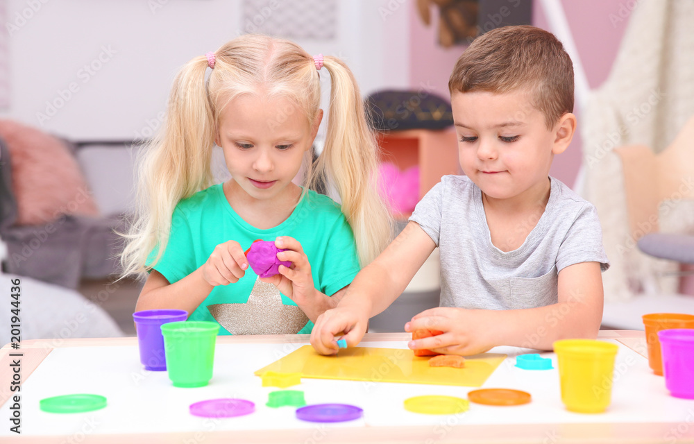 Cute little children modeling from playdough at home Cute little children modeling from playdough at home