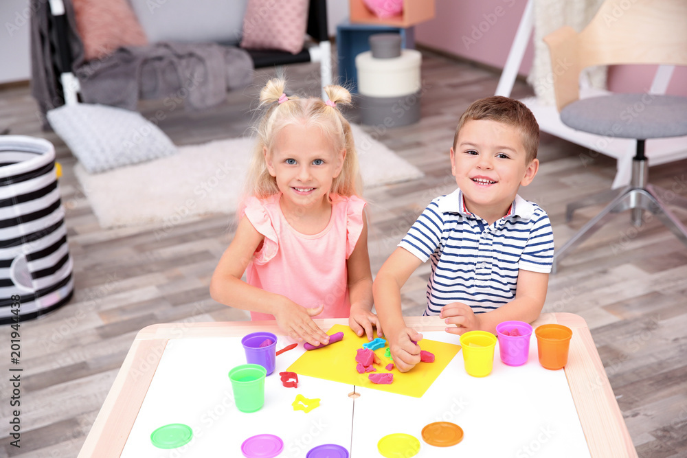 Fototapeta premium Cute little children modeling from playdough at home