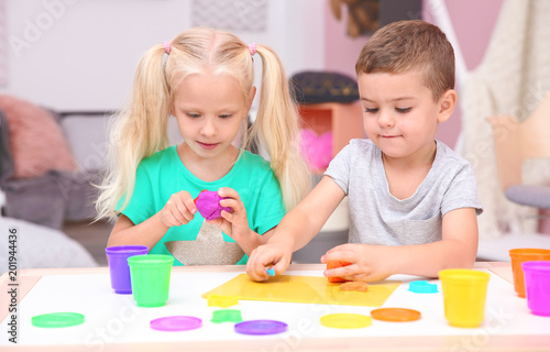 Cute little children modeling from playdough at home