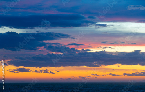 Colourful sunset with clouds and sunbeams