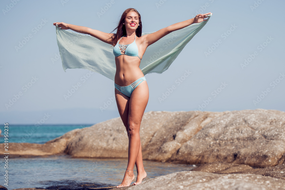Woman enjoying sunny day on tropical beach Woman enjoying sunny day on tropical beach