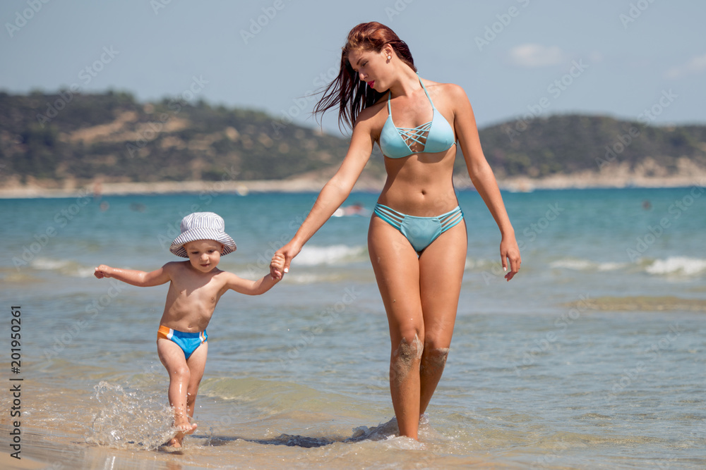 Woman with her son on the beach