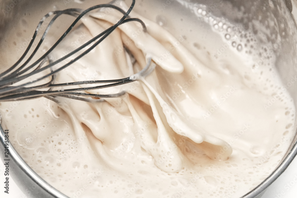 Fototapeta premium culinary whisk whipping white liquid, dough, cream