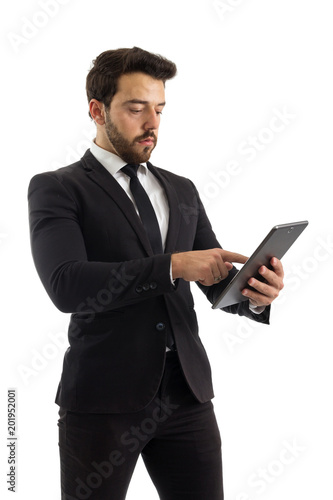 Man is using a digital tablet. Beautiful and elegant person is wearing black suit..