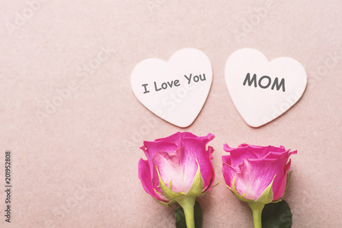 Pink roses and heart shape with I Love You Mom text in mother's day