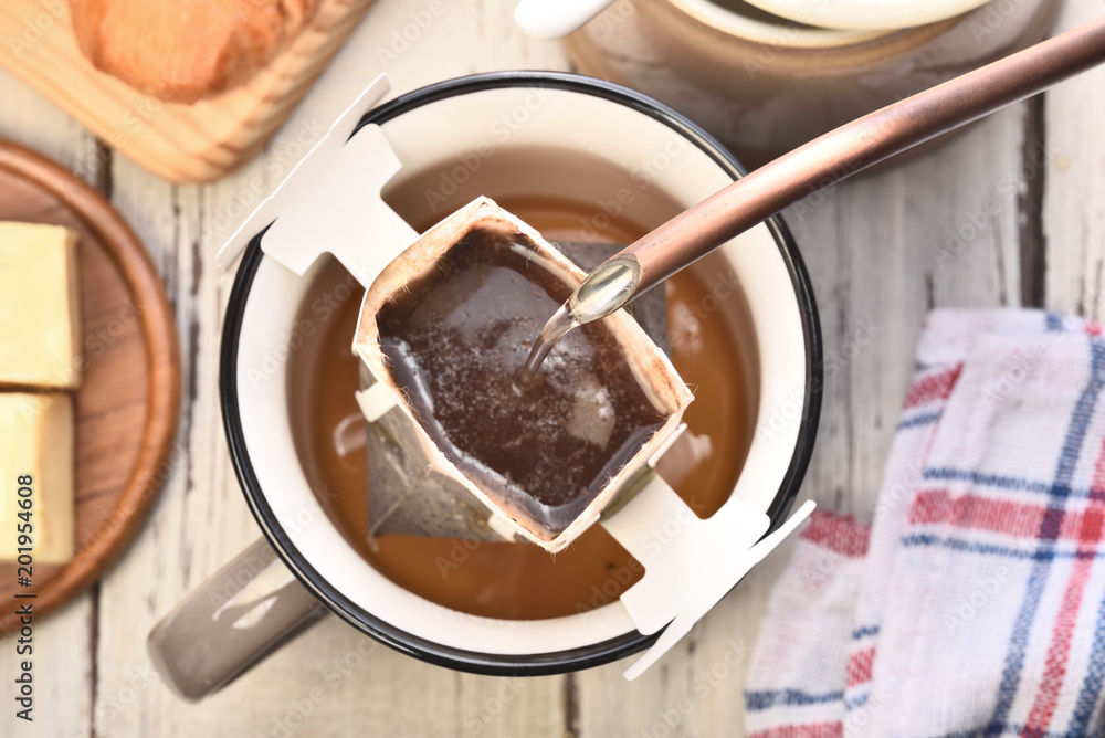 Instant freshly brewed cup of coffee on a wooden table Instant freshly brewed cup of coffee on a wooden table