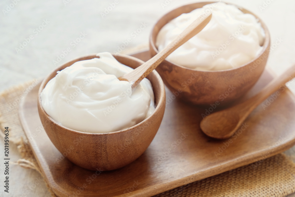 homemade organic coconut greek yogurt in wooden bowl homemade organic coconut greek yogurt in wooden bowl