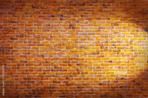 Vntage brick wall background with right sideway spotlight on the wall
