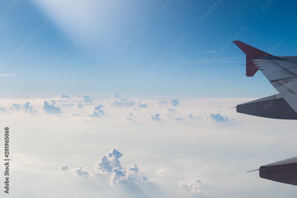The plane is flying through the blue sky The plane is flying through the blue sky