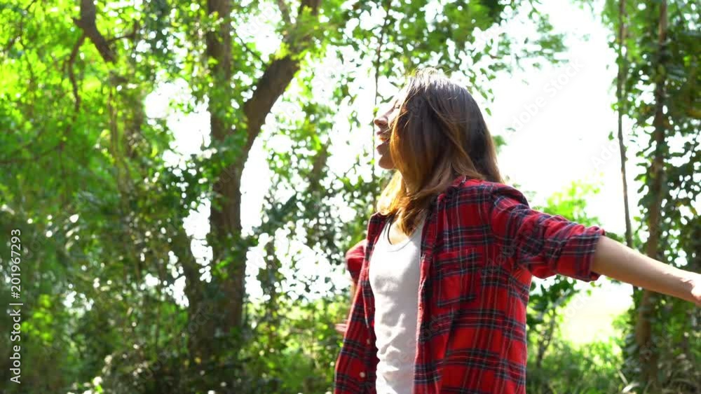 Happy young Asian woman traveler with backpack walking in forest. Hiker Asian woman with backpack walking on path in summer forest. Adventure backpacker travel people concept. Happy young Asian woman traveler with backpack walking in forest. Hiker Asian woman with backpack walking on path in summer forest. Adventure backpacker travel people concept.