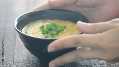 Serving a bowl rice porridge