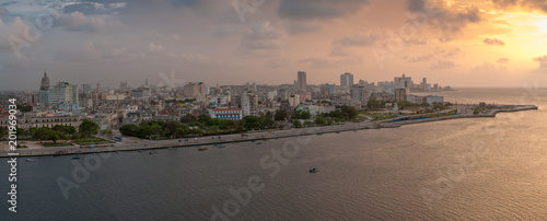 Panoramic of the city of Havana at sunset, where you can see a fisherman's boat leaving the bay to the open sea. Havana Cuba photo