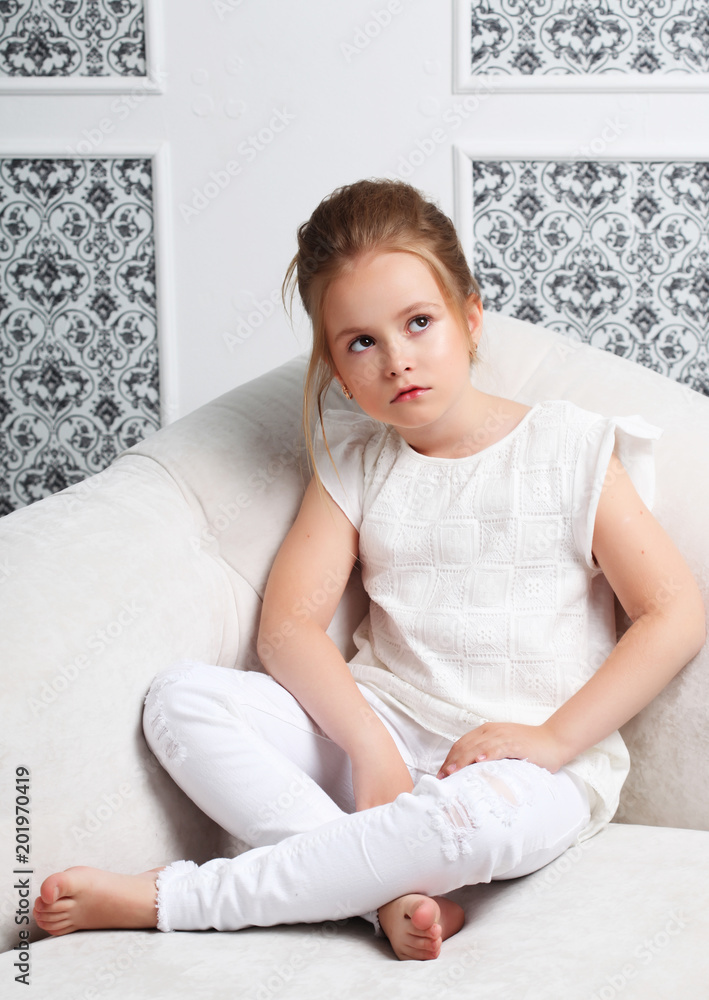 Girl fashion portrait. Child model sitting in chair. Girl fashion portrait. Child model sitting in chair.