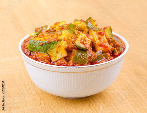 Indian Traditional Raw Mango Pickle Also Know as Aam Ka Achar or Kari Ka Achar on Wooden Background