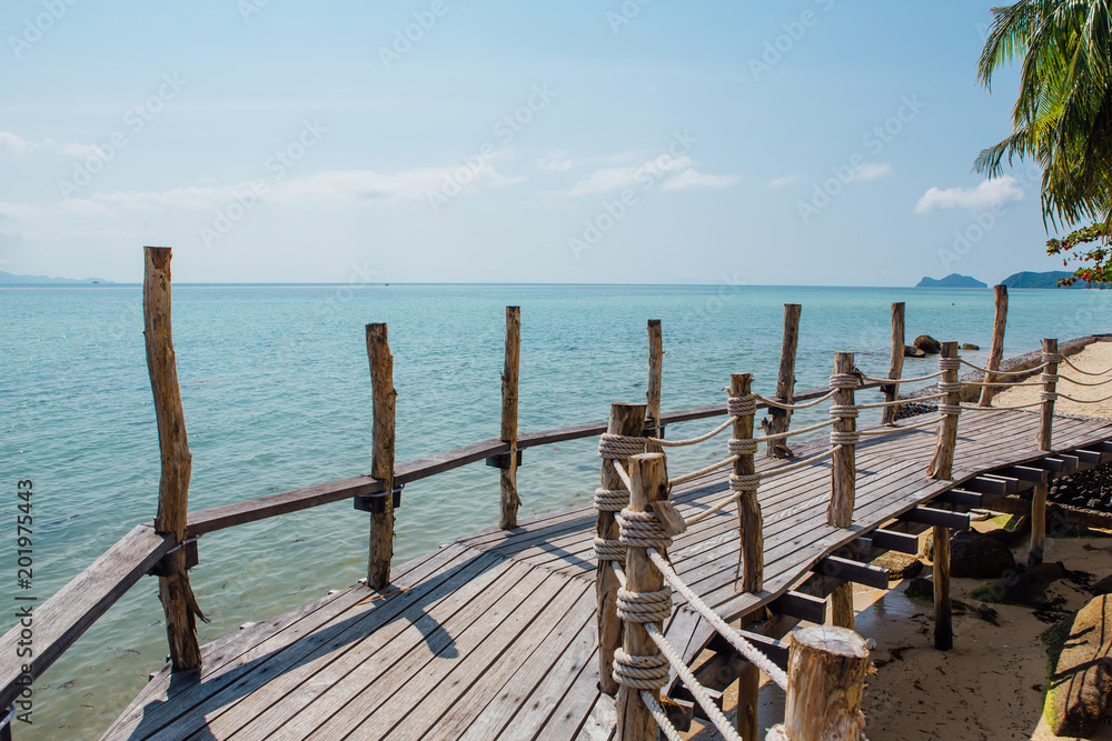 Paradise beach with wooden bridge