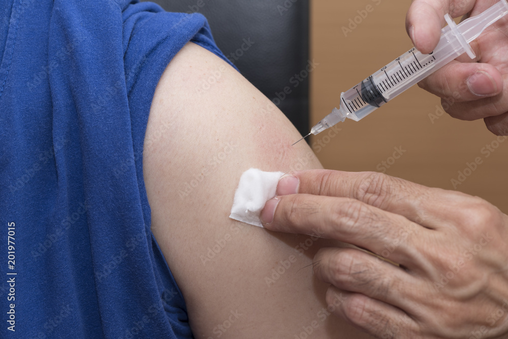 Doctor giving an injection to the patient Doctor giving an injection to the patient