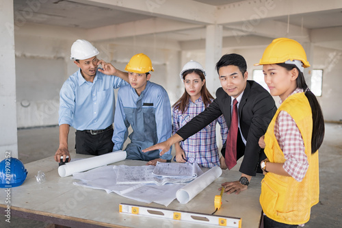 Businessman working with Architect  Engineer in building Construction Site with blueprint.Checking project plan.