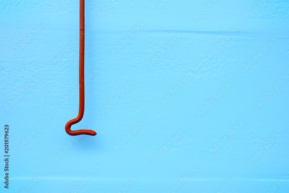 Close-up Old Cabin Hook Latch with Blue Painting on Concrete Wall. Close-up Old Cabin Hook Latch with Blue Painting on Concrete Wall.