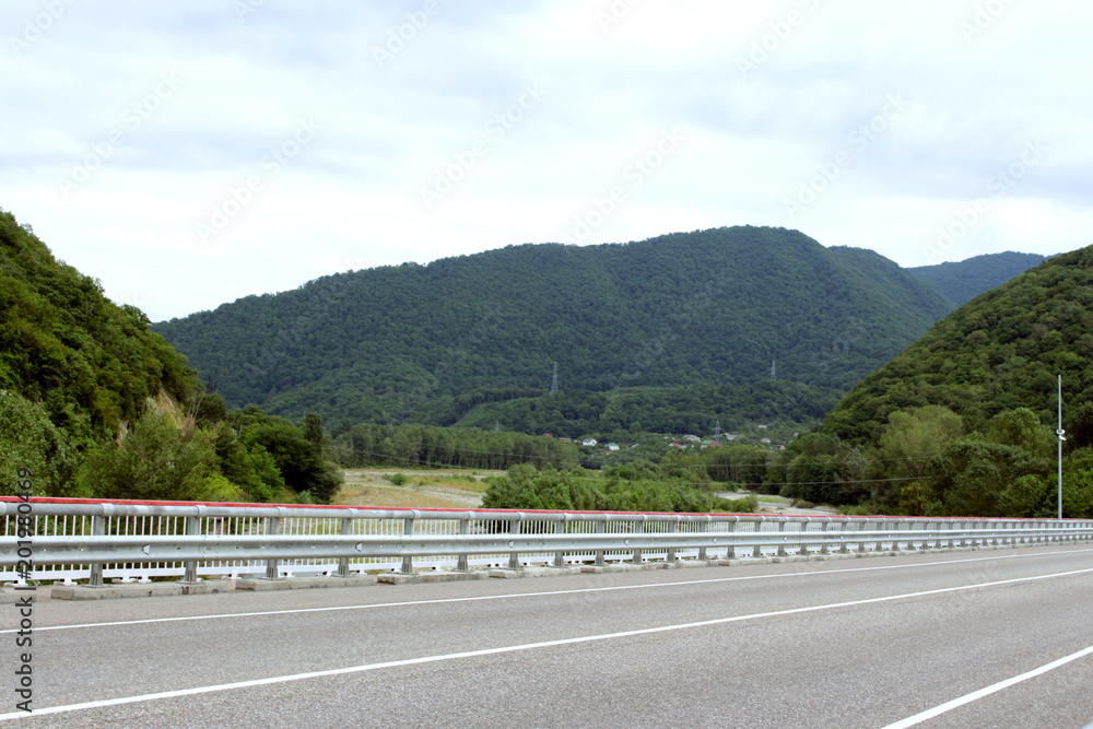 Driving on asphalt road and mountains on the horizon Driving on asphalt road and mountains on the horizon
