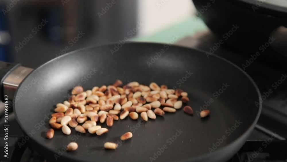 A close up shot of soyabean being roasted on a pan.