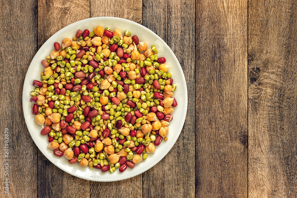 Beans, peas and hummus in a white plate on the table Beans, peas and hummus in a white plate on the table