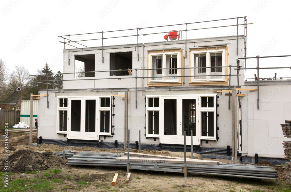 Building site with house under construction Building site with house under construction