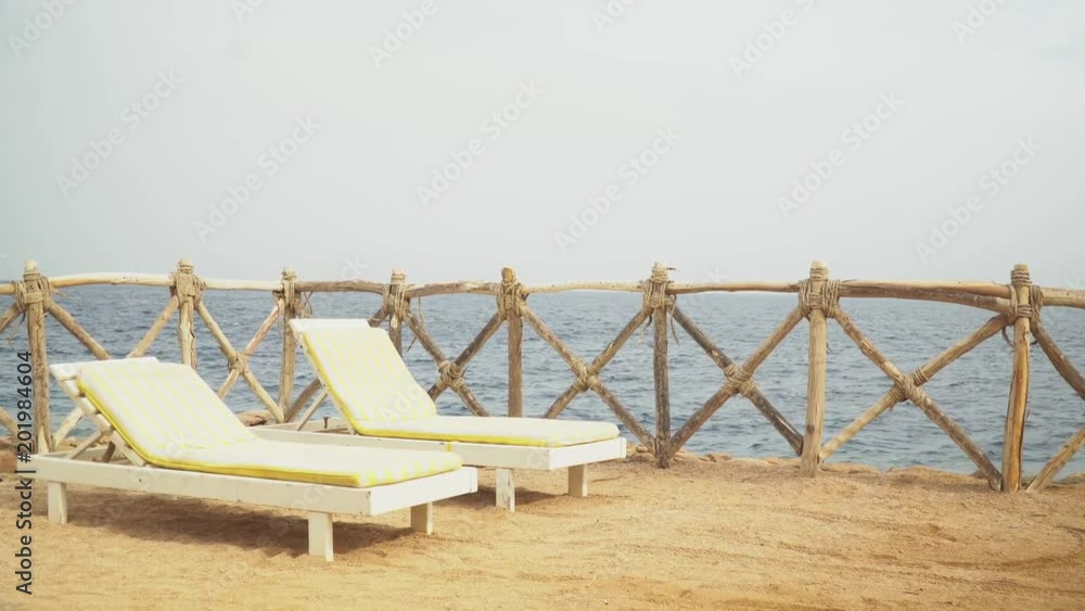 Egypt, Empty Sunny Beach with Umbrellas, Sun Beds on the Red Sea. Egypt, Empty Sunny Beach with Umbrellas, Sun Beds on the Red Sea.