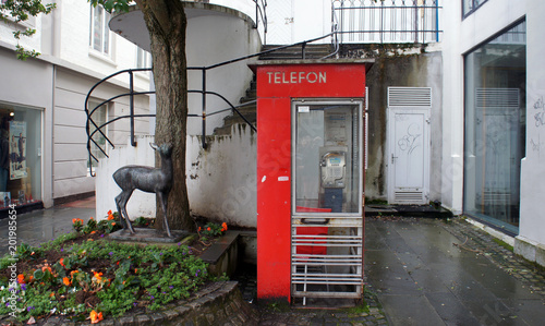 Alesund, Norway - Red phone booth in norwegian town, beautiful old city centre