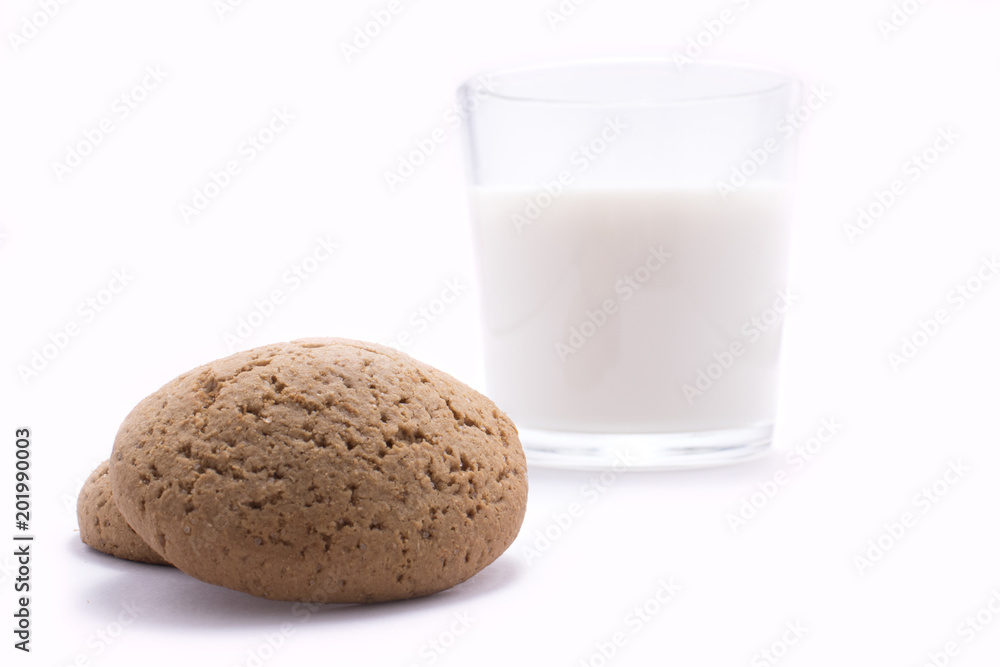 Oatmeal cookies behind which stands a glass of milk Oatmeal cookies behind which stands a glass of milk